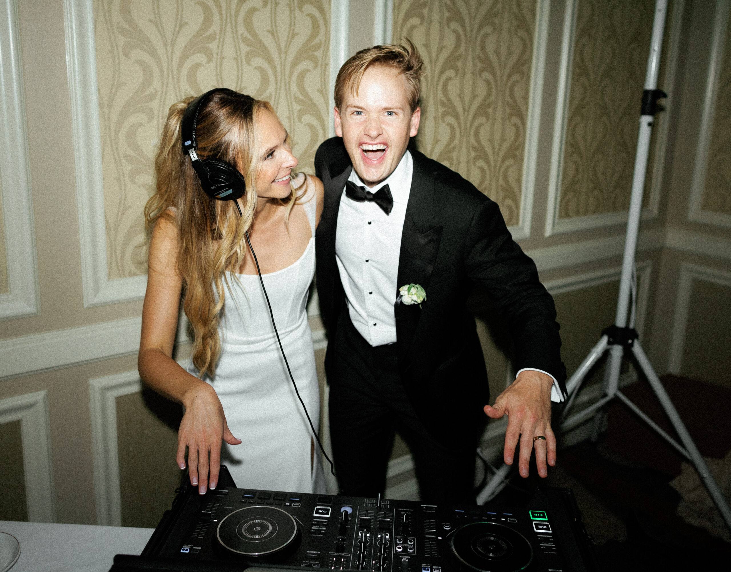 Happy couple at DJ booth with their Dallas Wedding DJ and Fort Worth Wedding DJ how much does a wedding dj cost